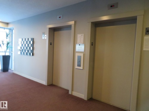 Hall with elevator and carpet flooring - 415 2590 Anderson Way, Edmonton, AB - Indoor Photo Showing Other Room