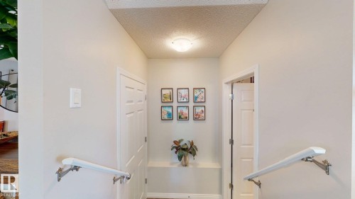 Hall featuring a textured ceiling and baseboards - 1275 Chappelle Boulevard, Edmonton, AB - Indoor