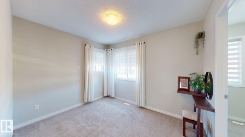 Spare room with light carpet and a textured ceiling - 1275 Chappelle Boulevard, Edmonton, AB - Indoor Photo Showing Other Room