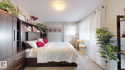 Bedroom with a textured ceiling and light colored carpet - 1275 Chappelle Boulevard, Edmonton, AB - Indoor Photo Showing Bedroom