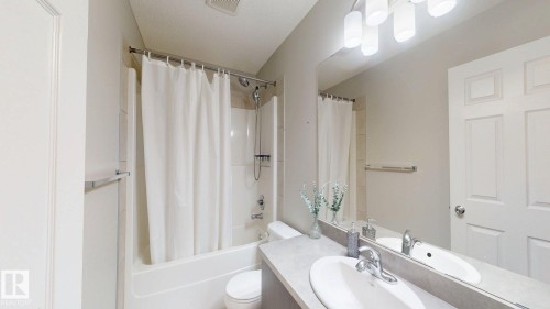 Bathroom featuring vanity and shower / bath combo with shower curtain - 1275 Chappelle Boulevard, Edmonton, AB - Indoor Photo Showing Bathroom