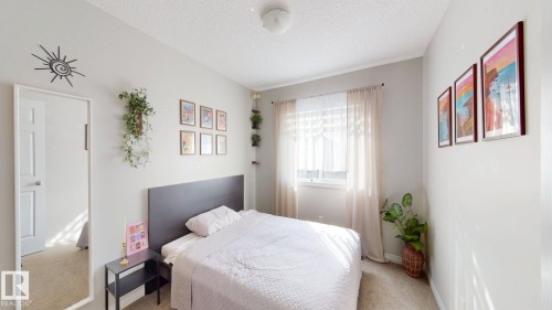Bedroom with light colored carpet and a textured ceiling - 1275 Chappelle Boulevard, Edmonton, AB - Indoor Photo Showing Bedroom