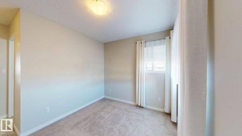 Unfurnished room with light colored carpet and a textured ceiling - 1275 Chappelle Boulevard, Edmonton, AB - Indoor Photo Showing Other Room
