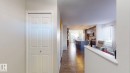 Hall with dark wood finished floors, a textured ceiling, and plenty of natural light - 1275 Chappelle Boulevard, Edmonton, AB  - Indoor Photo Showing Other Room 
