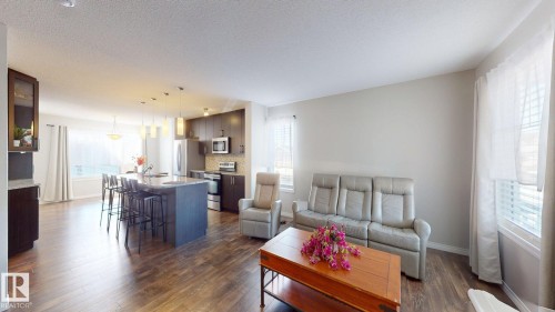 Living room with dark wood finished floors and a textured ceiling - 1275 Chappelle Boulevard, Edmonton, AB - Indoor Photo Showing Living Room