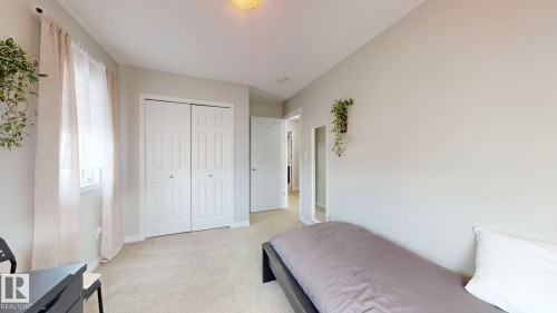 Bedroom featuring light-colored walls, carpeted flooring, and a window with sheer curtains - 1275 Chappelle Boulevard, Edmonton, AB - Indoor Photo Showing Bedroom