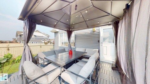 The property features a patio with a gazebo, string lights, and exterior siding - 1275 Chappelle Boulevard, Edmonton, AB - 
