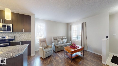 Living area featuring dark wood-style floors and a textured ceiling - 1275 Chappelle Boulevard, Edmonton, AB - Indoor