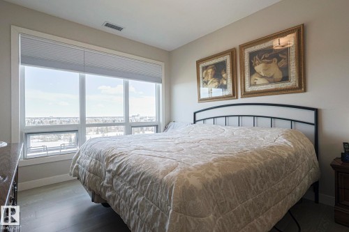 Bedroom featuring baseboards and dark wood-style flooring - 910 2755 109 Street, Edmonton, AB - Indoor Photo Showing Bedroom