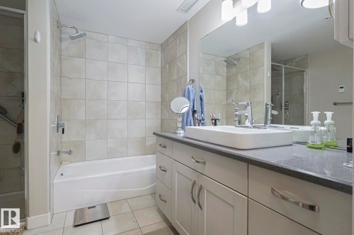 Full bathroom featuring a stall shower, vanity, light tile patterned floors, and a tub to relax in - 910 2755 109 Street, Edmonton, AB - Indoor Photo Showing Bathroom
