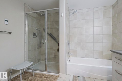 Bathroom with a shower stall, vanity, light tile patterned floors, and a bathtub - 910 2755 109 Street, Edmonton, AB - Indoor Photo Showing Bathroom