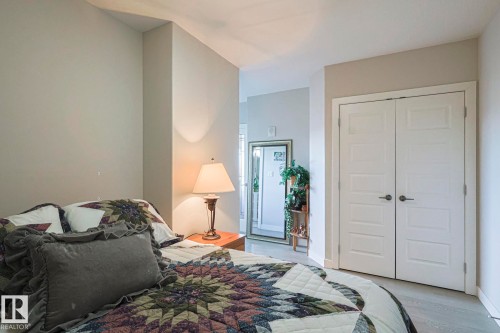 Bedroom featuring a closet and light wood-style floors - 910 2755 109 Street, Edmonton, AB - Indoor Photo Showing Bedroom