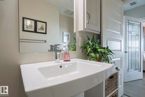 Bathroom featuring a sink and dark wood-style floors - 910 2755 109 Street, Edmonton, AB - Indoor Photo Showing Bathroom