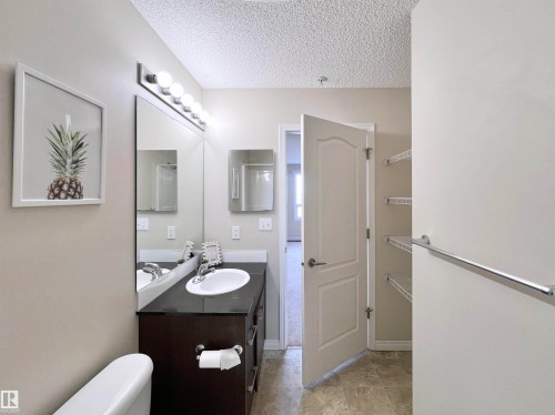 Half bath with vanity and a textured ceiling - 3308 9351 Simpson Drive, Edmonton, AB - Indoor Photo Showing Bathroom