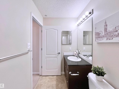 Bathroom with vanity and a textured ceiling - 3308 9351 Simpson Drive, Edmonton, AB - Indoor Photo Showing Bathroom
