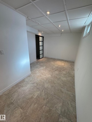 Finished basement with baseboards - 4801 52 Avenue, Andrew, AB - Indoor Photo Showing Other Room