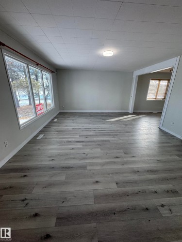 Spare room featuring plenty of natural light and light wood-style floors - 4801 52 Avenue, Andrew, AB - Indoor Photo Showing Other Room