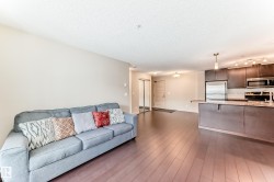 Living area featuring a textured ceiling and dark wood finished floors - 