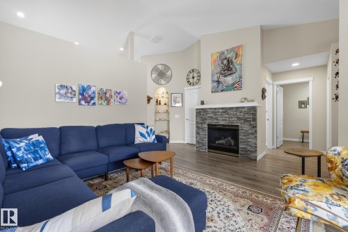 Living area with recessed lighting, wood finished floors, a fireplace, and a high ceiling - 30 4 Heritage Way, St. Albert, AB - Indoor Photo Showing Living Room With Fireplace