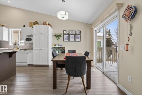 Dining room featuring lofted ceiling and dark wood finished floors - 30 4 Heritage Way, St. Albert, AB - Indoor