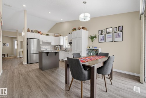 Dining area with lofted ceiling, light wood-type flooring, and recessed lighting - 30 4 Heritage Way, St. Albert, AB - Indoor