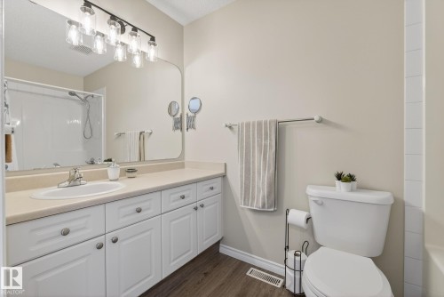 Full bathroom featuring vanity, dark wood-type flooring, and tub / shower combination - 30 4 Heritage Way, St. Albert, AB - Indoor Photo Showing Bathroom