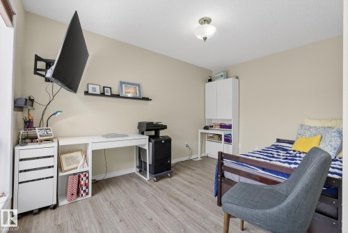 Bedroom featuring light wood-style floors and a desk - 30 4 Heritage Way, St. Albert, AB - Indoor