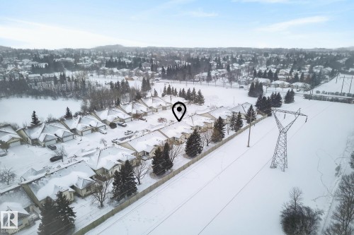 Snowy aerial view featuring a residential view - 30 4 Heritage Way, St. Albert, AB - Outdoor With View