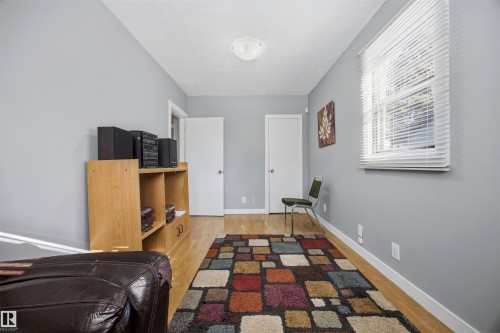 South-facing Bedroom with light laminate flooring and baseboards. - 4209 116 Avenue, Edmonton, AB - Indoor Photo Showing Other Room