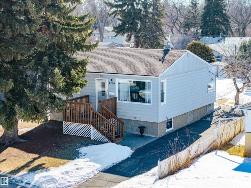 View of front of home featuring a shingled roof, a porch area, and a wooden deck - 4209 116 Avenue, Edmonton, AB - Outdoor