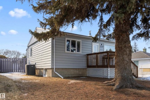 View of house front of house featuring the air conditioning unit and a wooden deck - 4209 116 Avenue, Edmonton, AB - Outdoor With Deck Patio Veranda