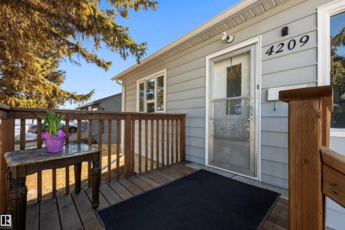 View of front door and wooden deck/patio. - 4209 116 Avenue, Edmonton, AB - Outdoor With Deck Patio Veranda With Exterior