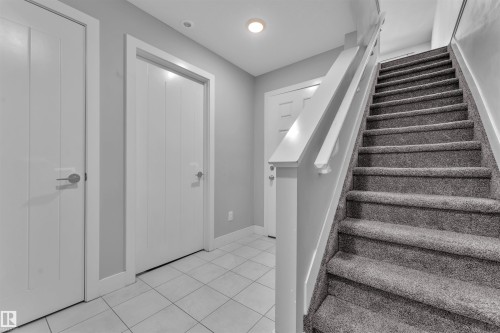 Stairs featuring baseboards and tile patterned floors - #38 1508 105 St Nw, Edmonton, AB - Indoor Photo Showing Other Room