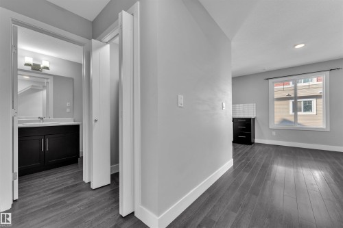 Hall featuring dark wood-style floors and recessed lighting - #38 1508 105 St Nw, Edmonton, AB - Indoor Photo Showing Other Room