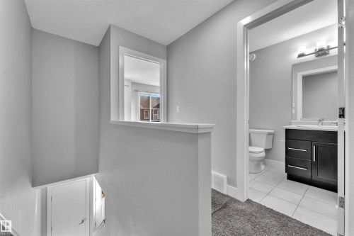 Half bathroom with vanity, light colored carpet, and light tile patterned floors - #38 1508 105 St Nw, Edmonton, AB - Indoor