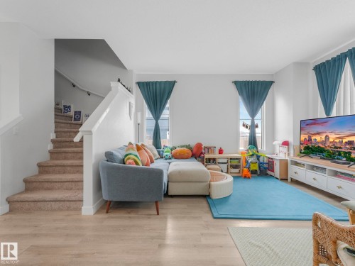 Living area with plenty of natural light and wood finished floors - 1404 Podersky Link, Edmonton, AB - Indoor