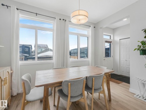 Dining space featuring light wood-style flooringHUGE WINDOWS - 1404 Podersky Link, Edmonton, AB - Indoor Photo Showing Dining Room