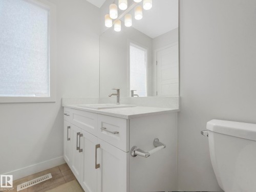 Half bath featuring toilet and vanity - 1404 Podersky Link, Edmonton, AB - Indoor Photo Showing Bathroom