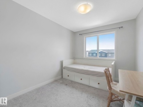 Bedroom with light carpet and baseboards - 1404 Podersky Link, Edmonton, AB - Indoor Photo Showing Bedroom