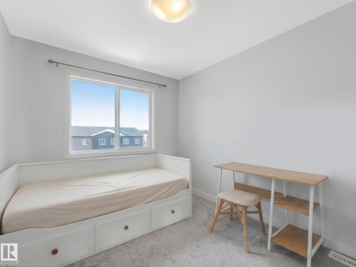 Bedroom featuring light colored carpet and baseboards - 1404 Podersky Link, Edmonton, AB - Indoor Photo Showing Bedroom