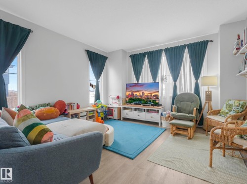 Living room featuring light wood-style floors and healthy amount of natural light - 1404 Podersky Link, Edmonton, AB - Indoor Photo Showing Living Room