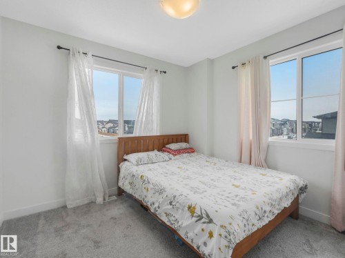 TONS OF NATURAL LIGHT FROM WINDOW TO WINDOW - 1404 Podersky Link, Edmonton, AB - Indoor Photo Showing Bedroom