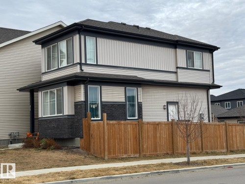 View of side of home featuring roof with shingles and brick siding - 1404 Podersky Link, Edmonton, AB - Outdoor