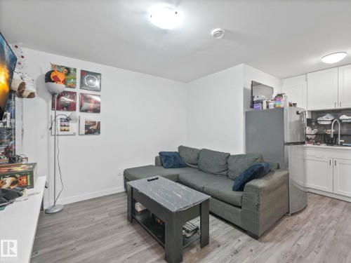 Living area featuring light wood-style flooring and baseboards - 1404 Podersky Link, Edmonton, AB - Indoor Photo Showing Living Room