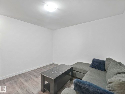 Living room featuring light wood-style flooring and baseboards - 1404 Podersky Link, Edmonton, AB - Indoor