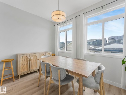 Dining room with light wood finished floors and baseboards - 1404 Podersky Link, Edmonton, AB - Indoor Photo Showing Dining Room