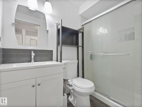 Full bath with vanity, a shower stall, dark wood-type flooring, and tasteful backsplash - 1404 Podersky Link, Edmonton, AB - Indoor Photo Showing Bathroom