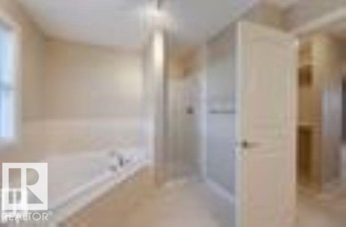 Bathroom with a garden tub and a shower stall - 1621 Cunningham Way Sw, Edmonton, AB - Indoor Photo Showing Bathroom