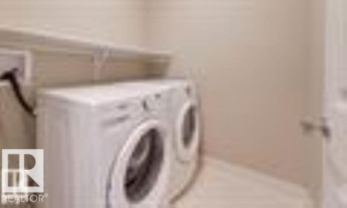 Laundry area with independent washer and dryer - 1621 Cunningham Way Sw, Edmonton, AB - Indoor