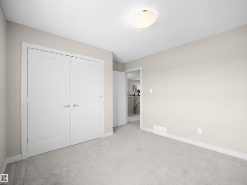 Unfurnished bedroom featuring light colored carpet and a closet - 1659 Hammond Crescent, Edmonton, AB - Indoor Photo Showing Other Room